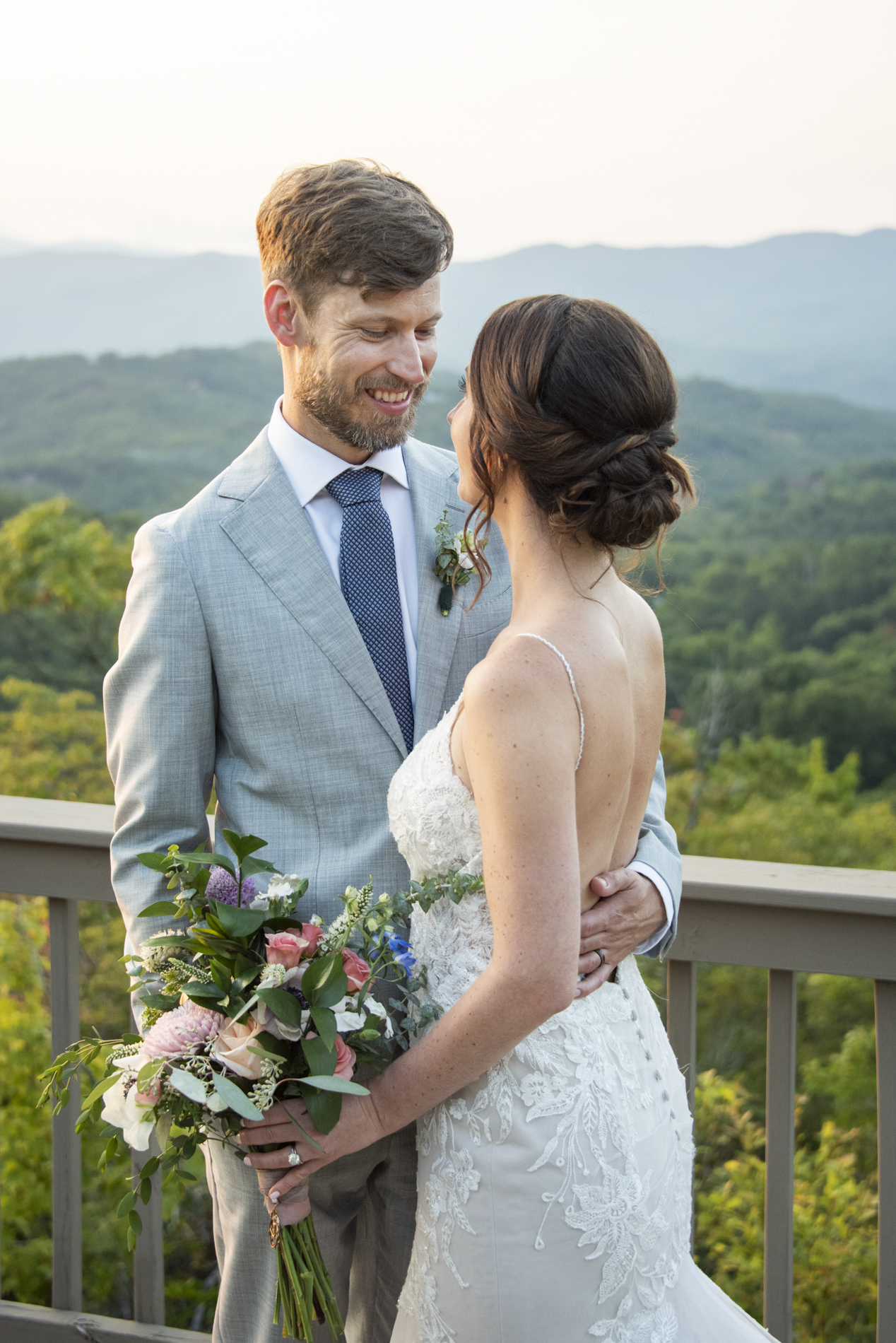 Couple smiling on mountain with Hawkesdene Wedding Photographer