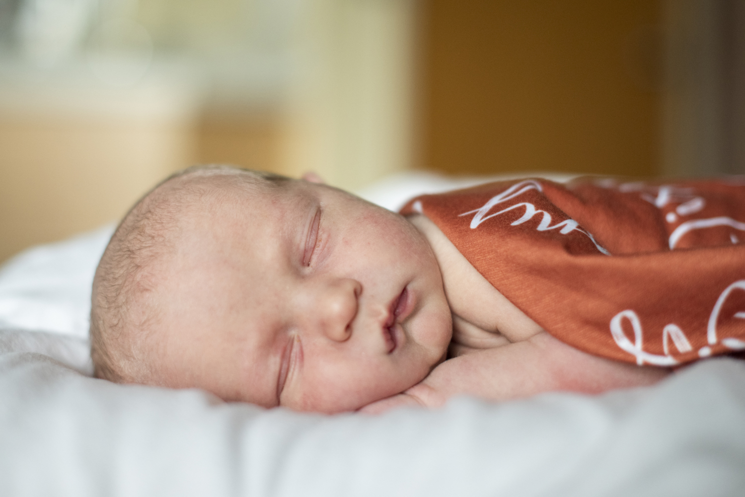 Baby boy on belly at Hospital Newborn Photography in Asheville