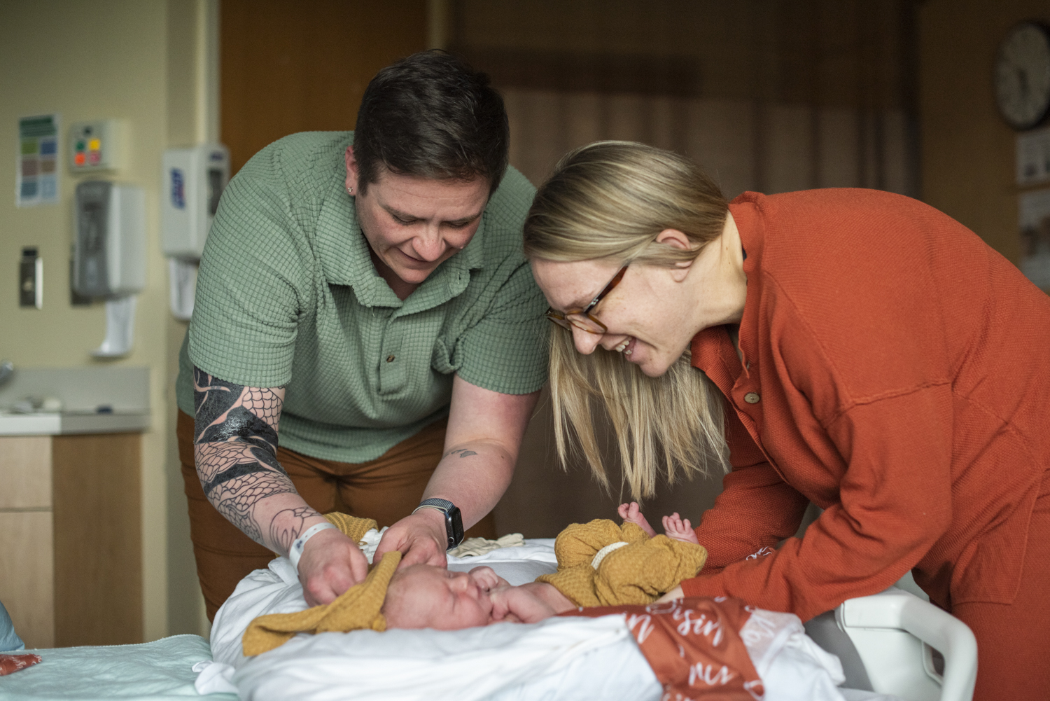 Parents dressing baby boy at Hospital Newborn Photography in Asheville