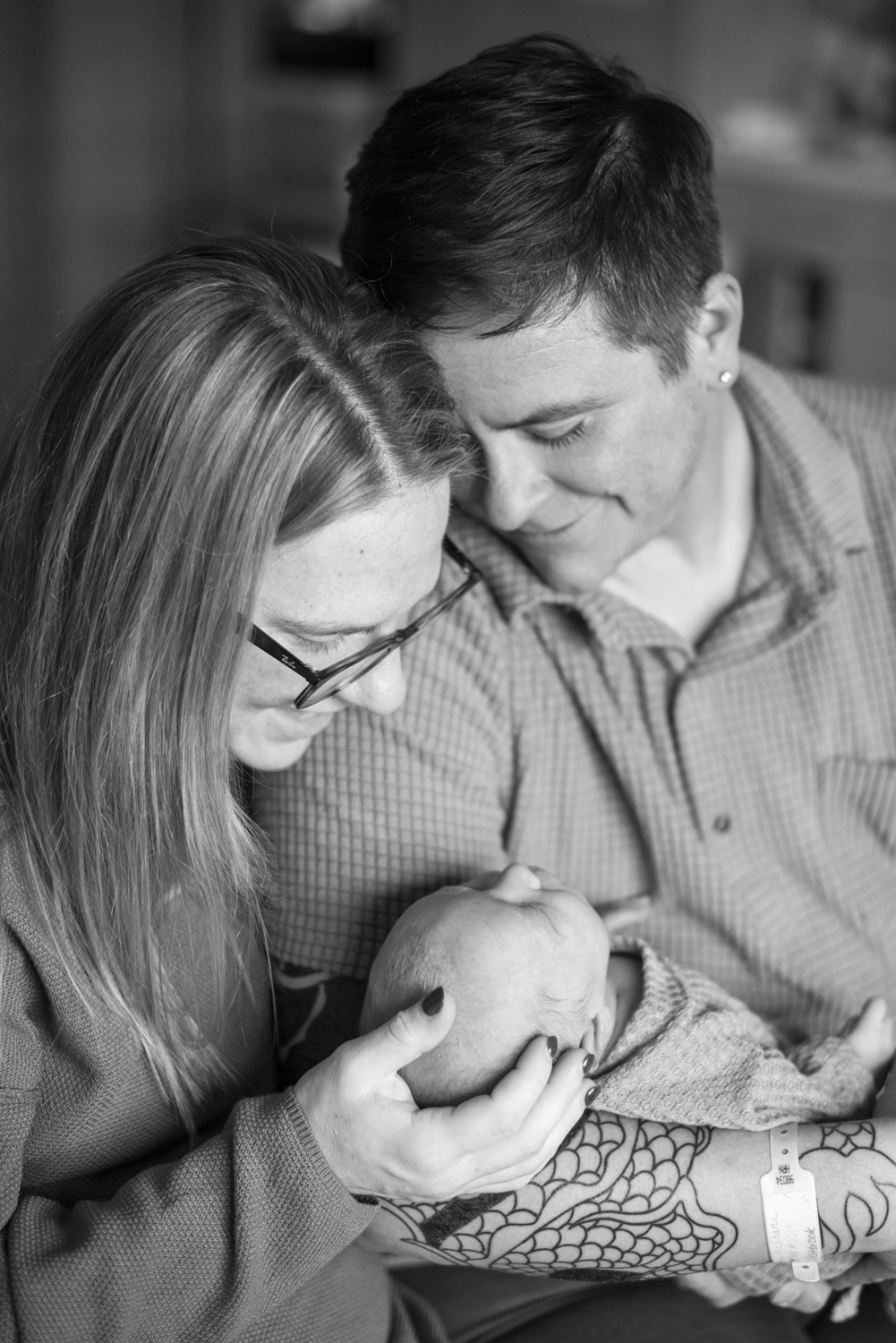 Parents smiling at baby at Hospital Newborn Photography in Asheville