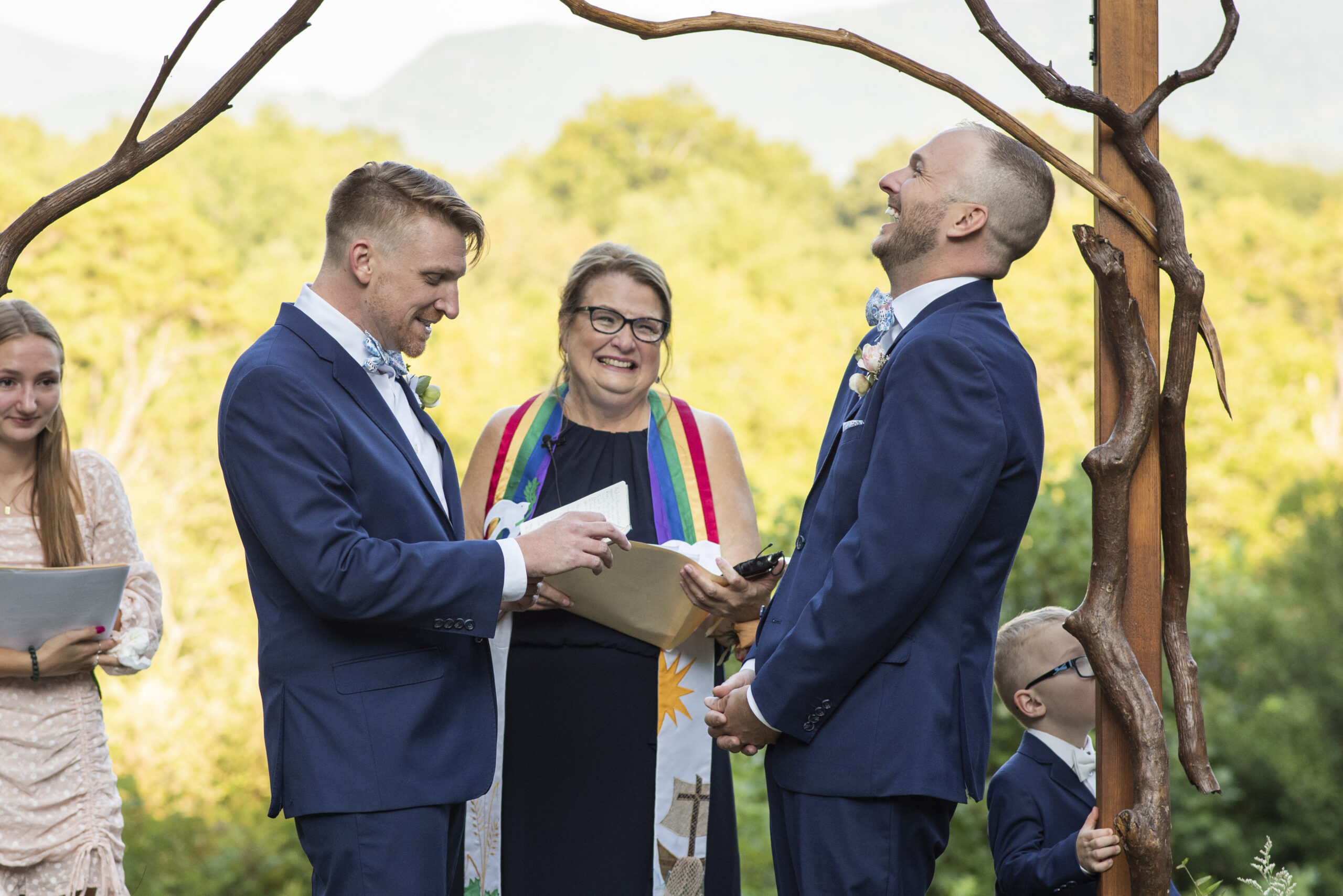 Gay couple laughing during ceremony at Twisty Maple Wedding Photography