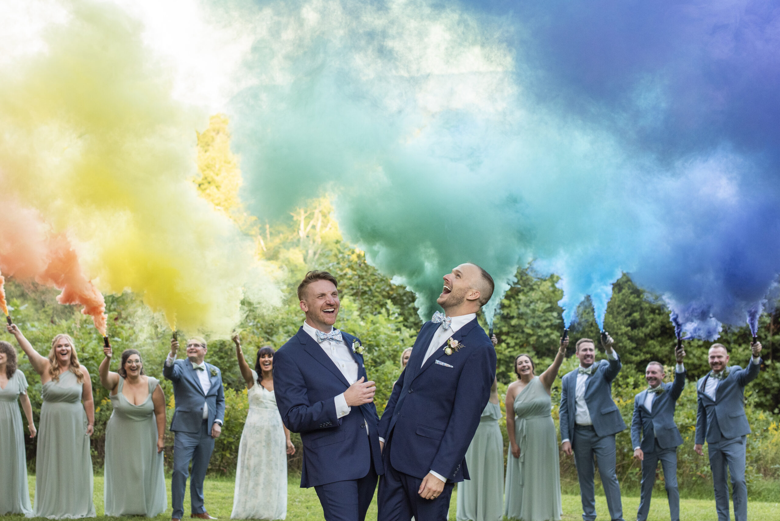 Twisty Maple Wedding Photography of gay couple under rainbow smoke bomb in Asheville, NC