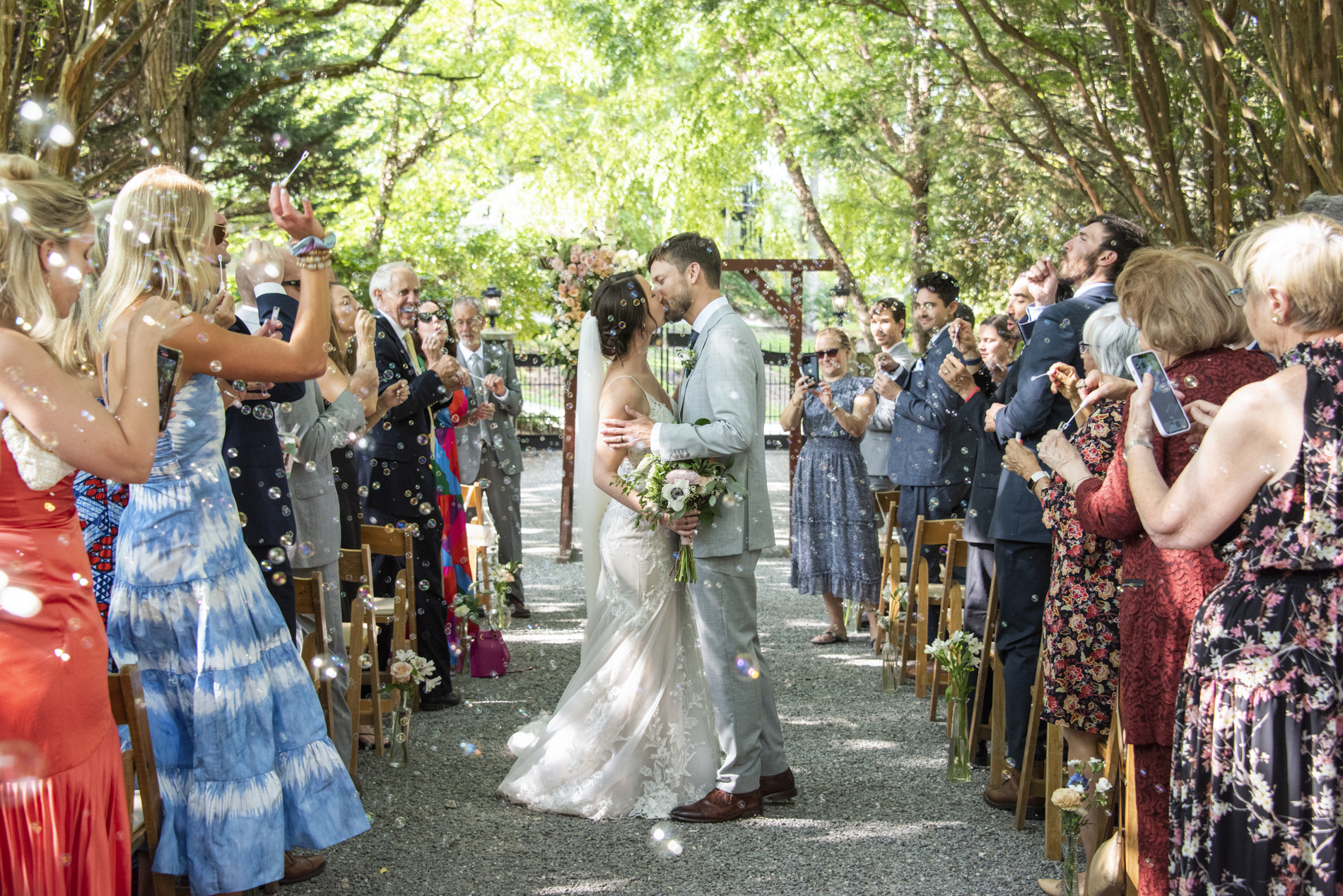 Couple kissing during bubble send off with Hawkesdene Wedding Photographer