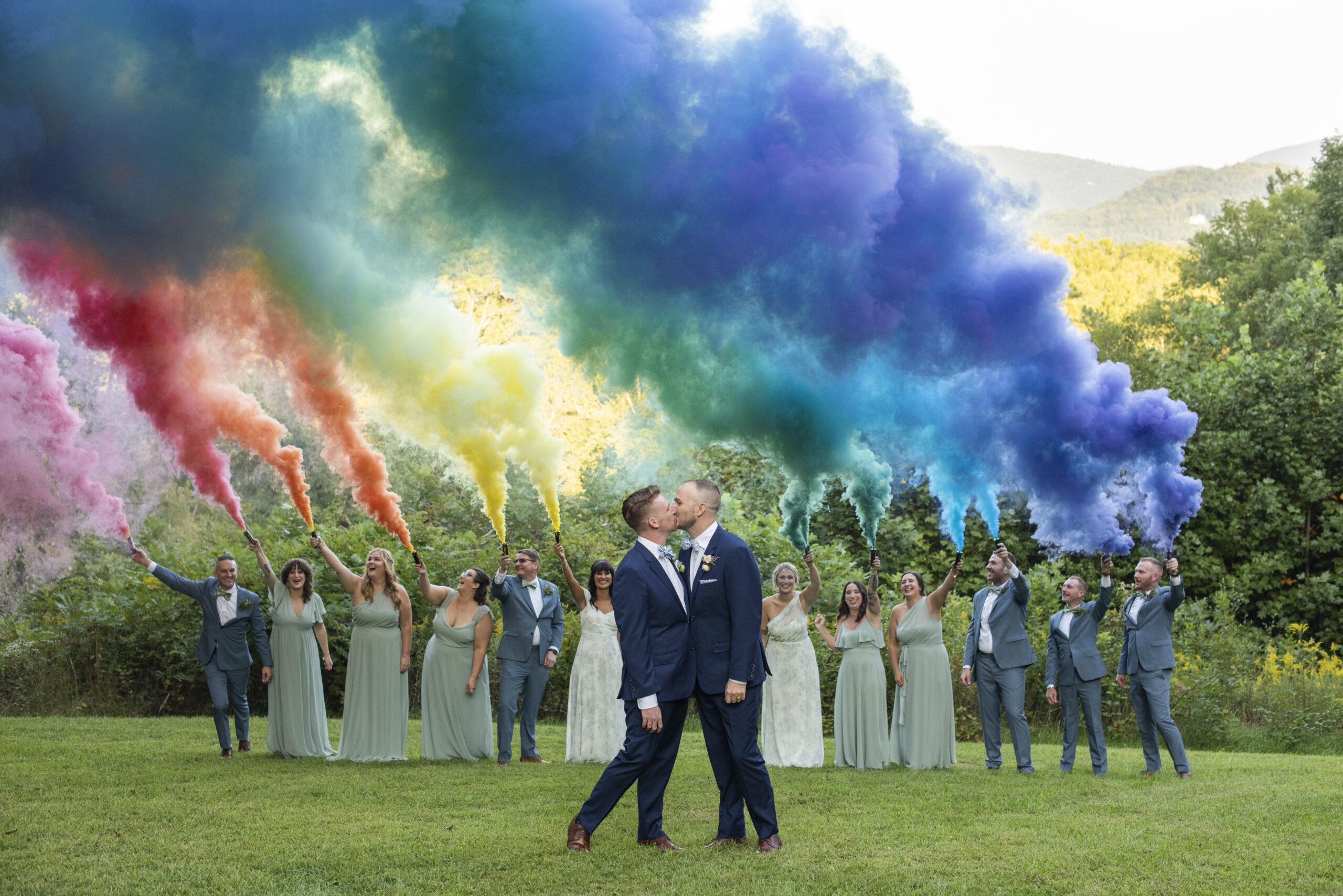 Queer couple kissing under rainbow smoke bomb at Twisty Maple Wedding Photography
