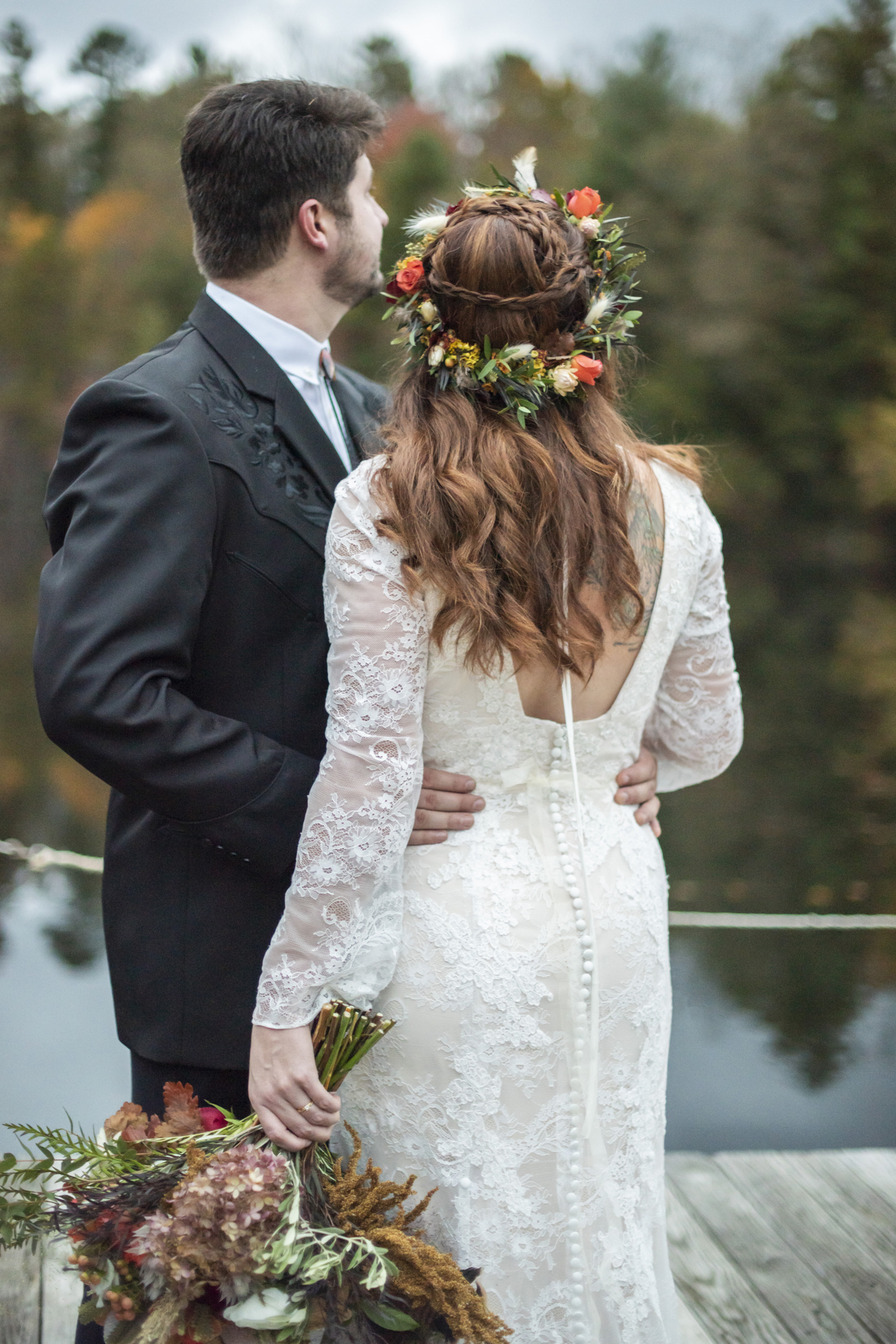 Couple looking at fall colors from dock on lake near Asheville