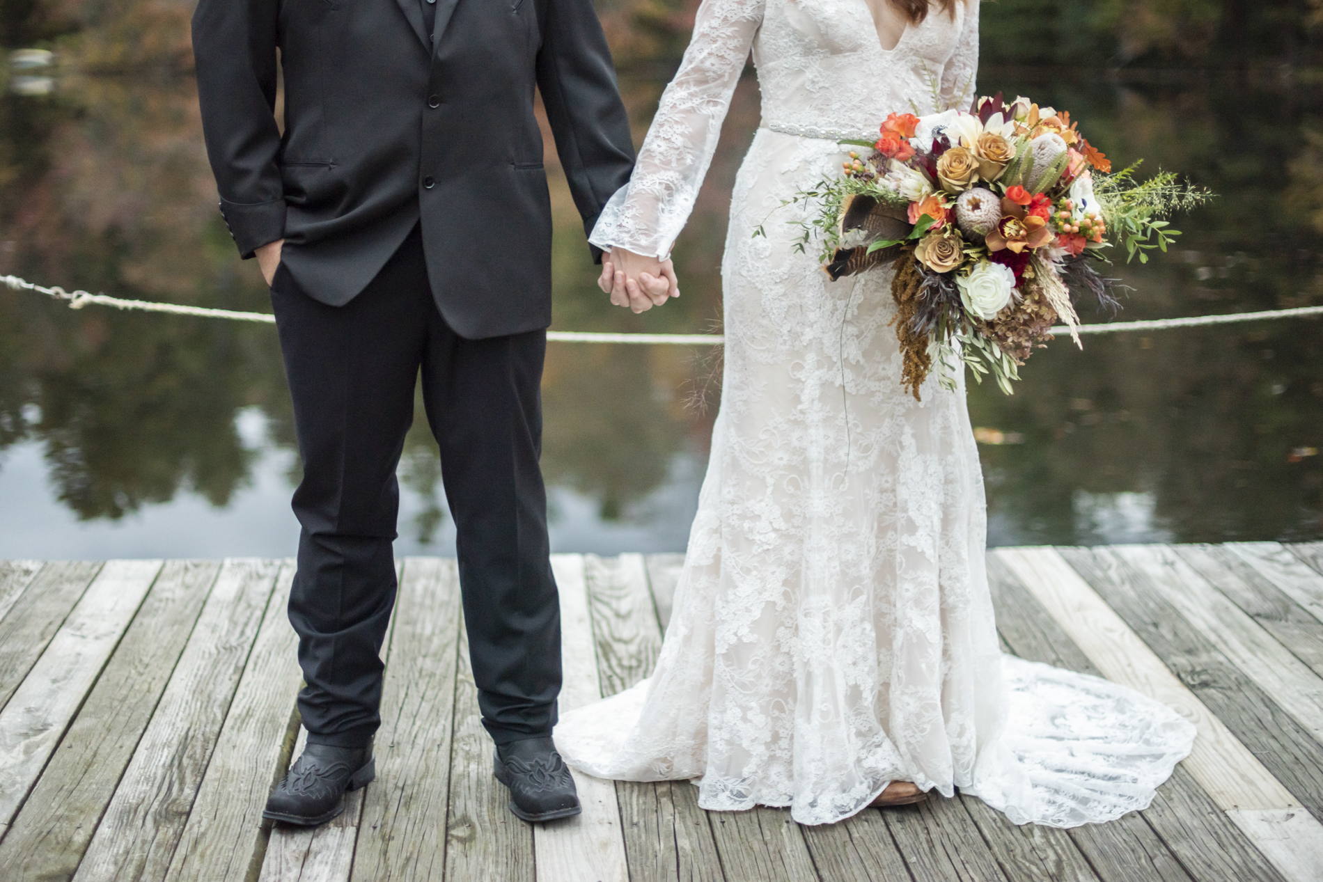 Couple's fall wedding attire on dock