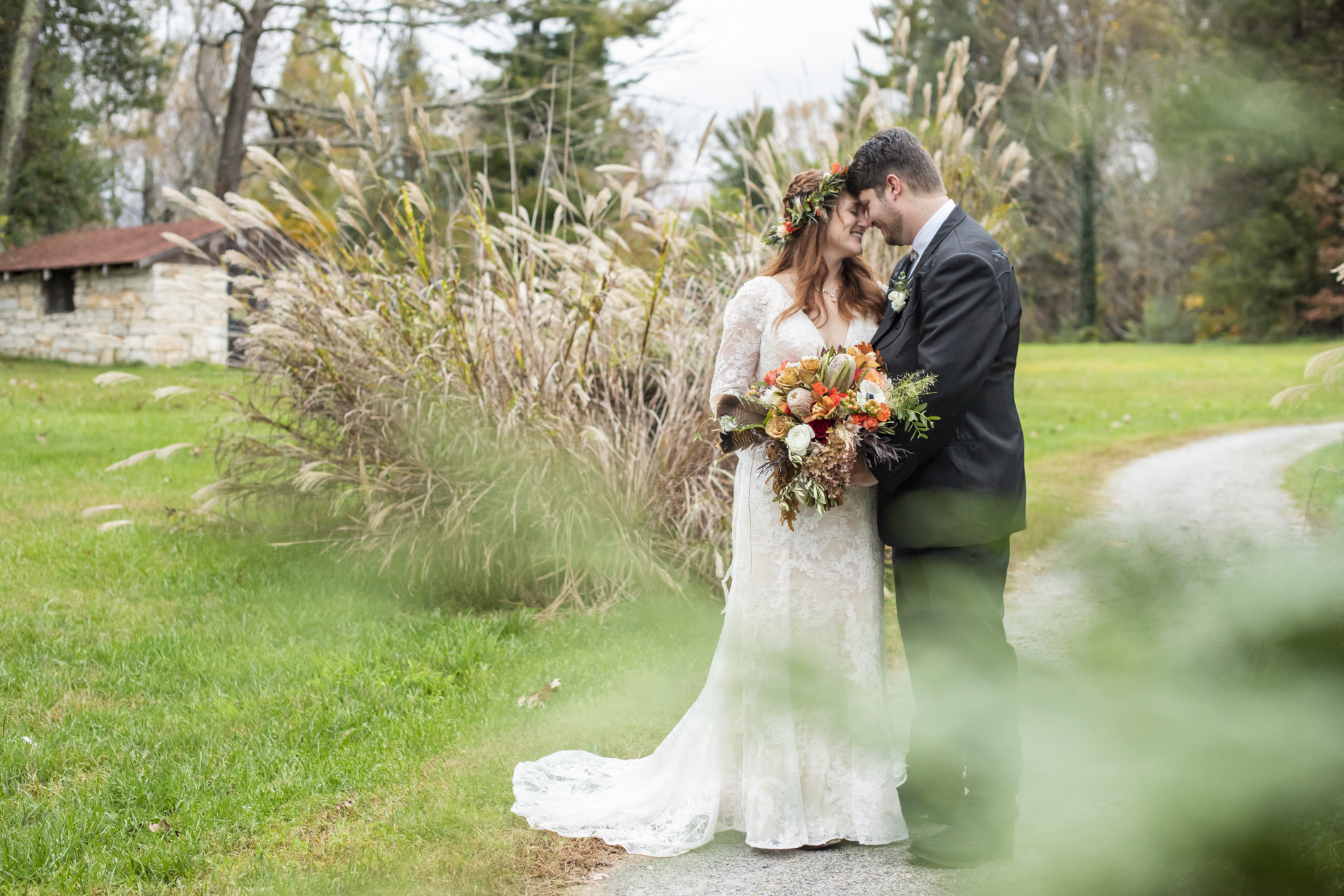 Couple snuggling during fall wedding at Highland Lake Inn