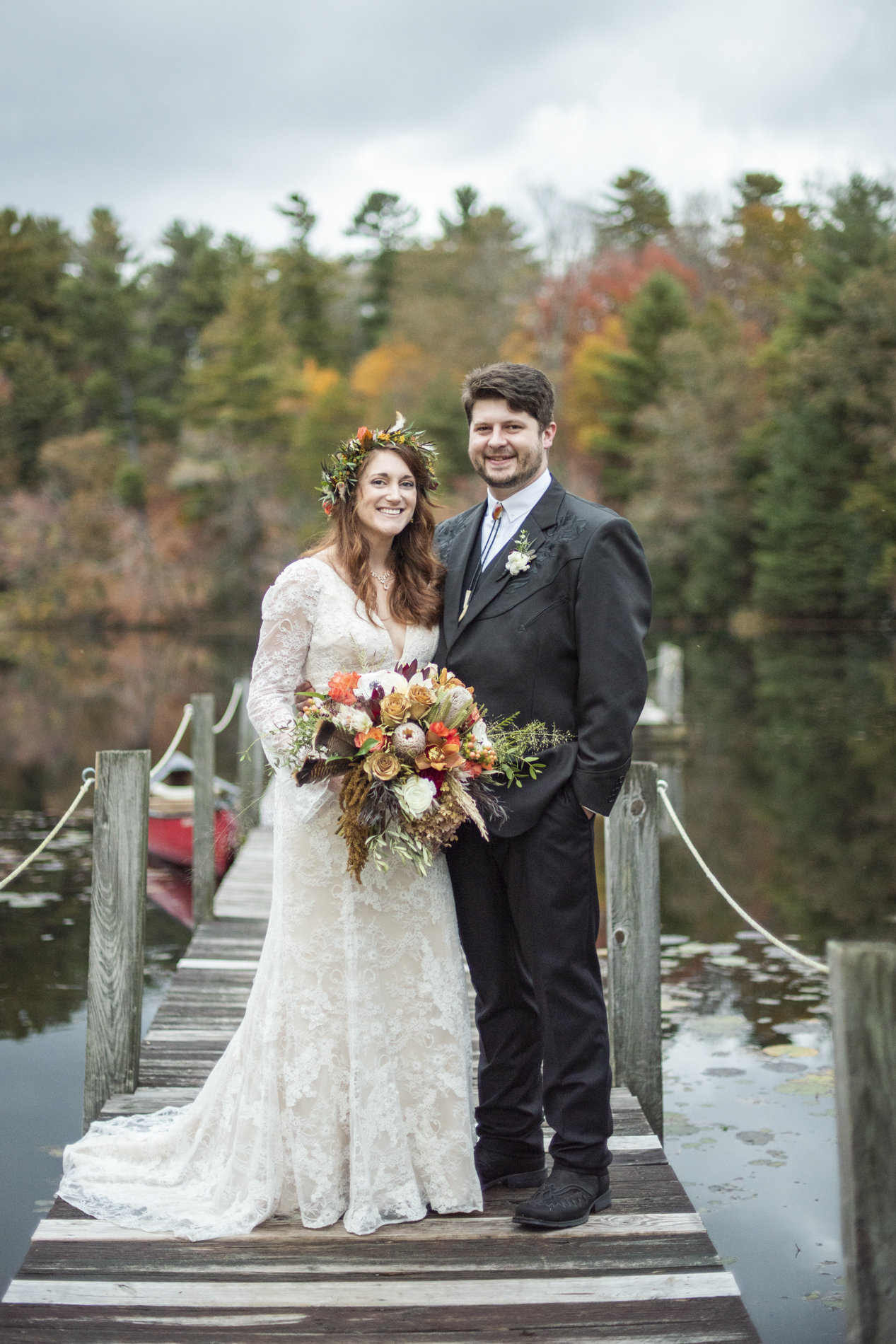 Couple's portrait on dock next to lake at Highland Lake Inn wedding