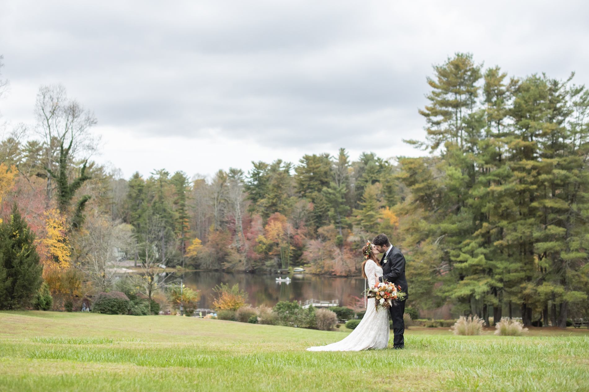 Couple kissing during fall wedding photos at Highland Lake Inn near Hendersonville NC