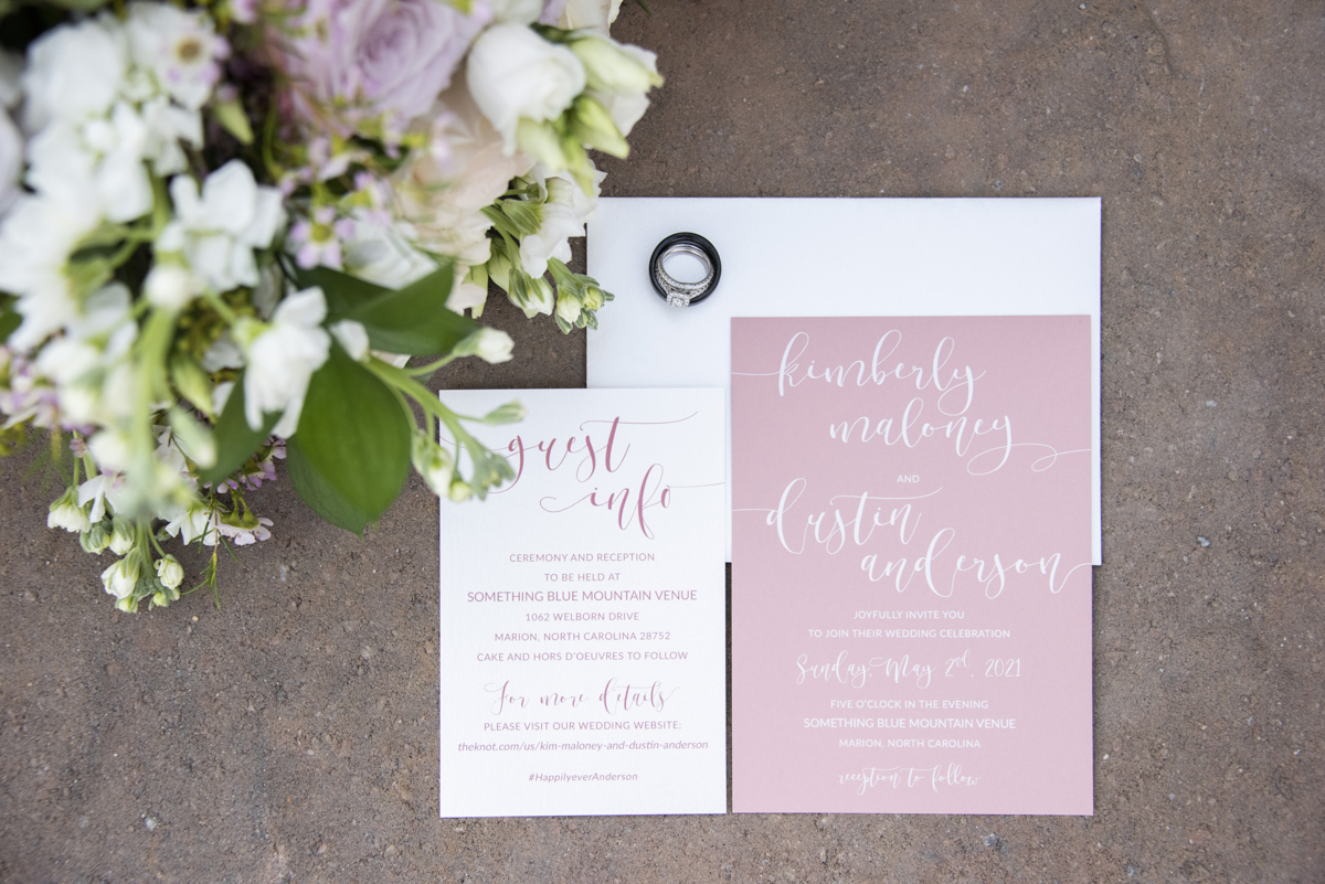 Invitation suite, rings, and bouquet detail photo