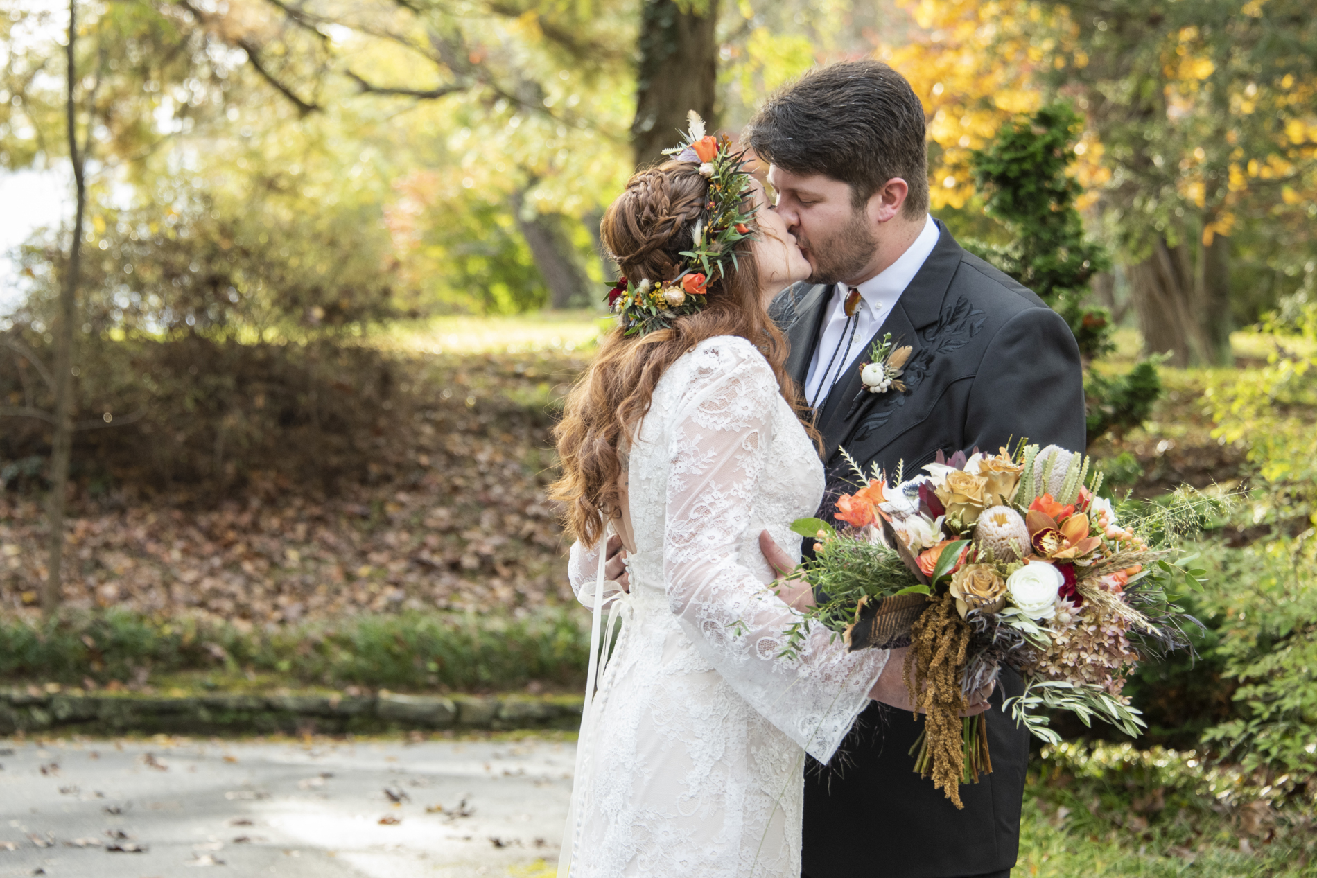 Couple kissing during fall wedding photos