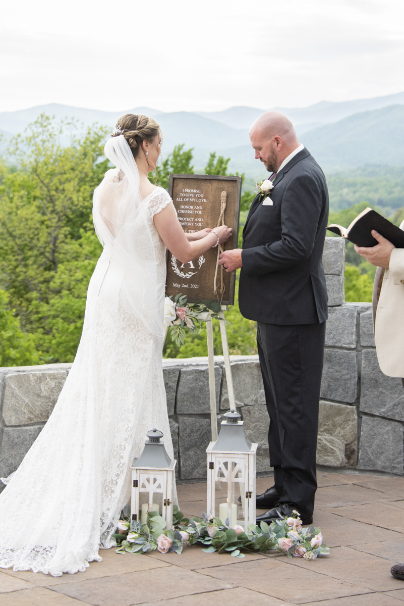 Couple braiding cord at wedding at Something Blue Mountain Venue