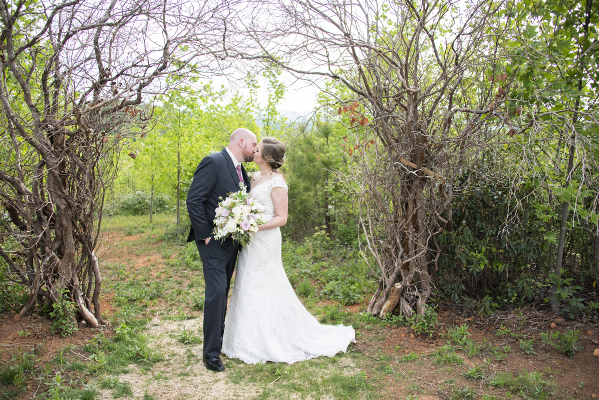 Couple kissing under trees