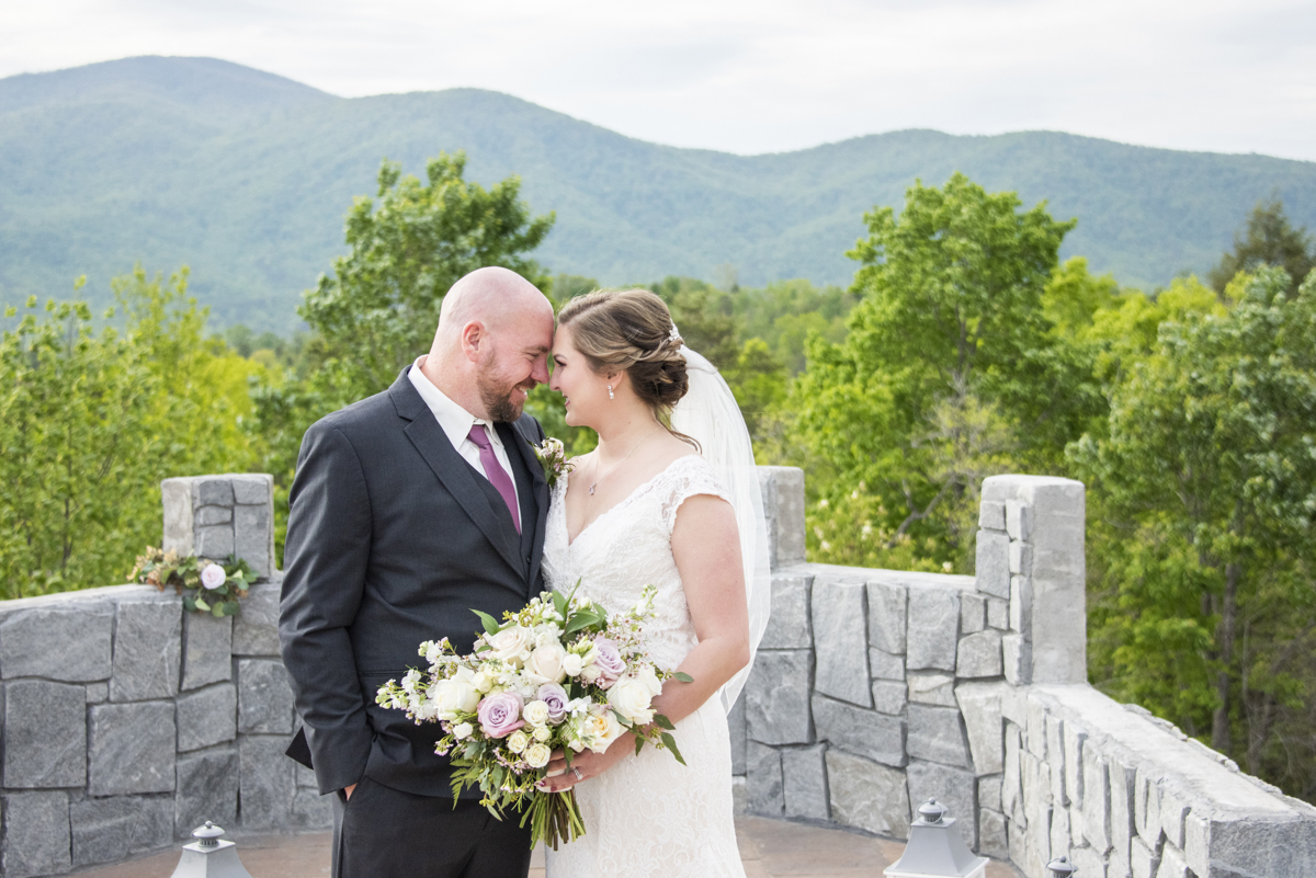 Couple snuggling during wedding photos at Something Blue Mountain Venue