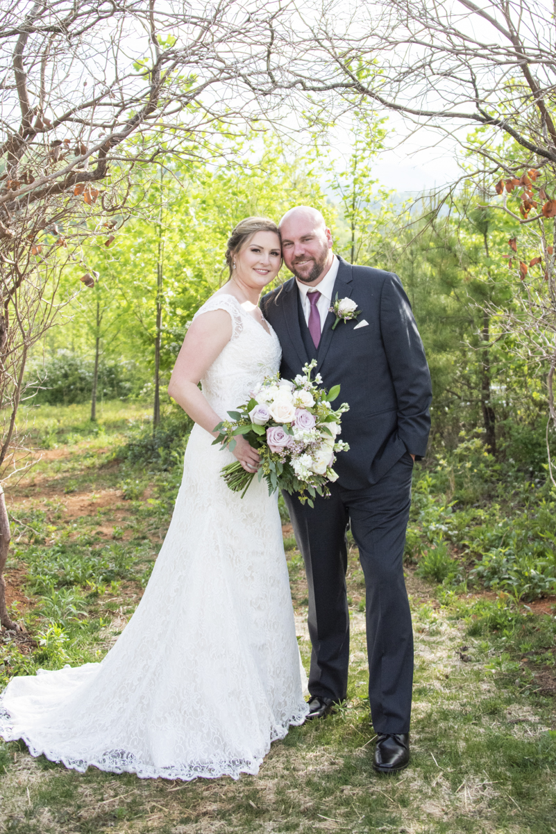 Wedding portrait of couple under trees