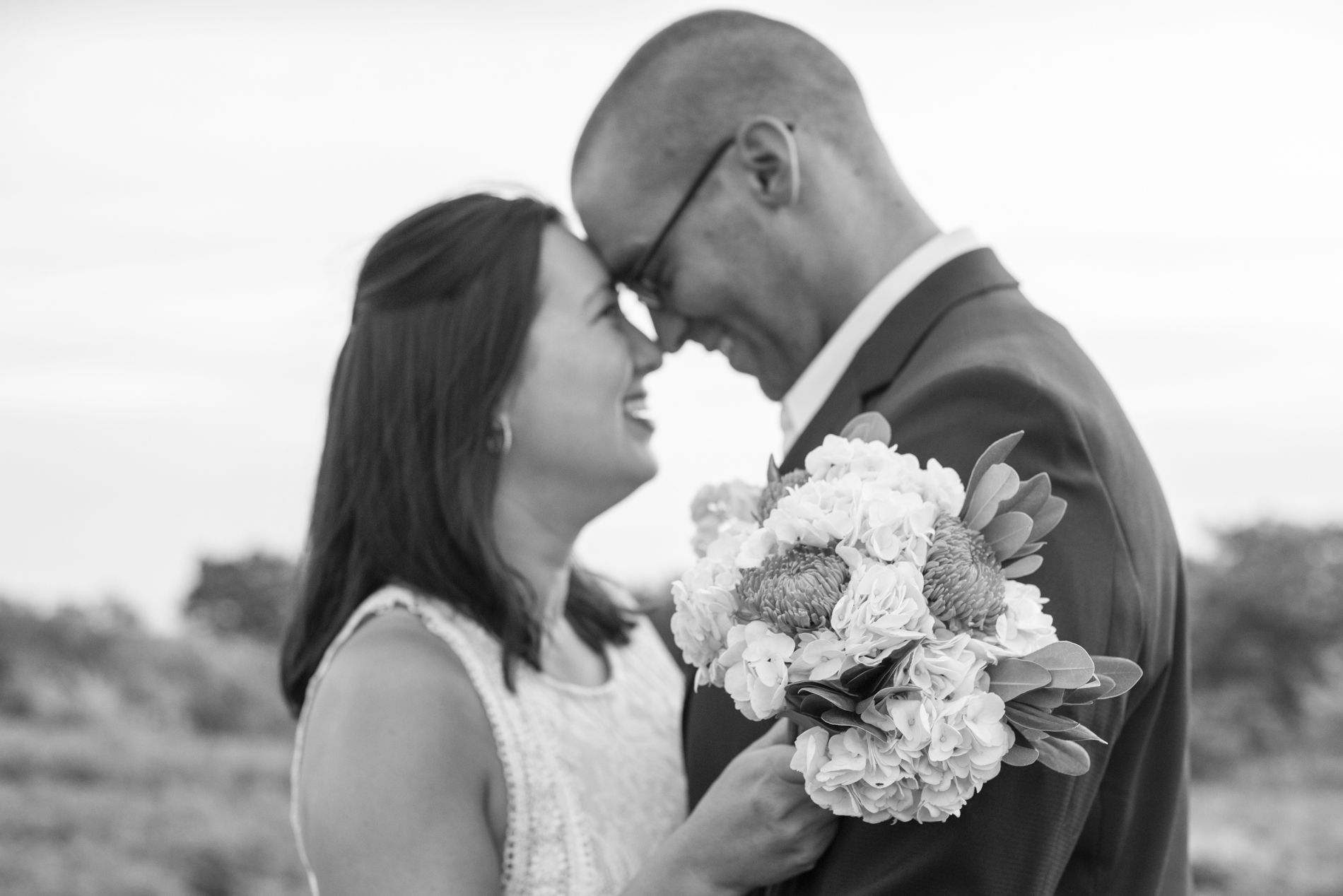 Couple touching noses during wedding photos