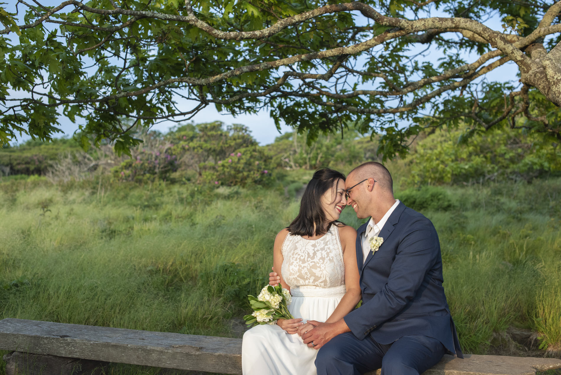 Couple sitting and snuggling during Craggy Gardens Wedding