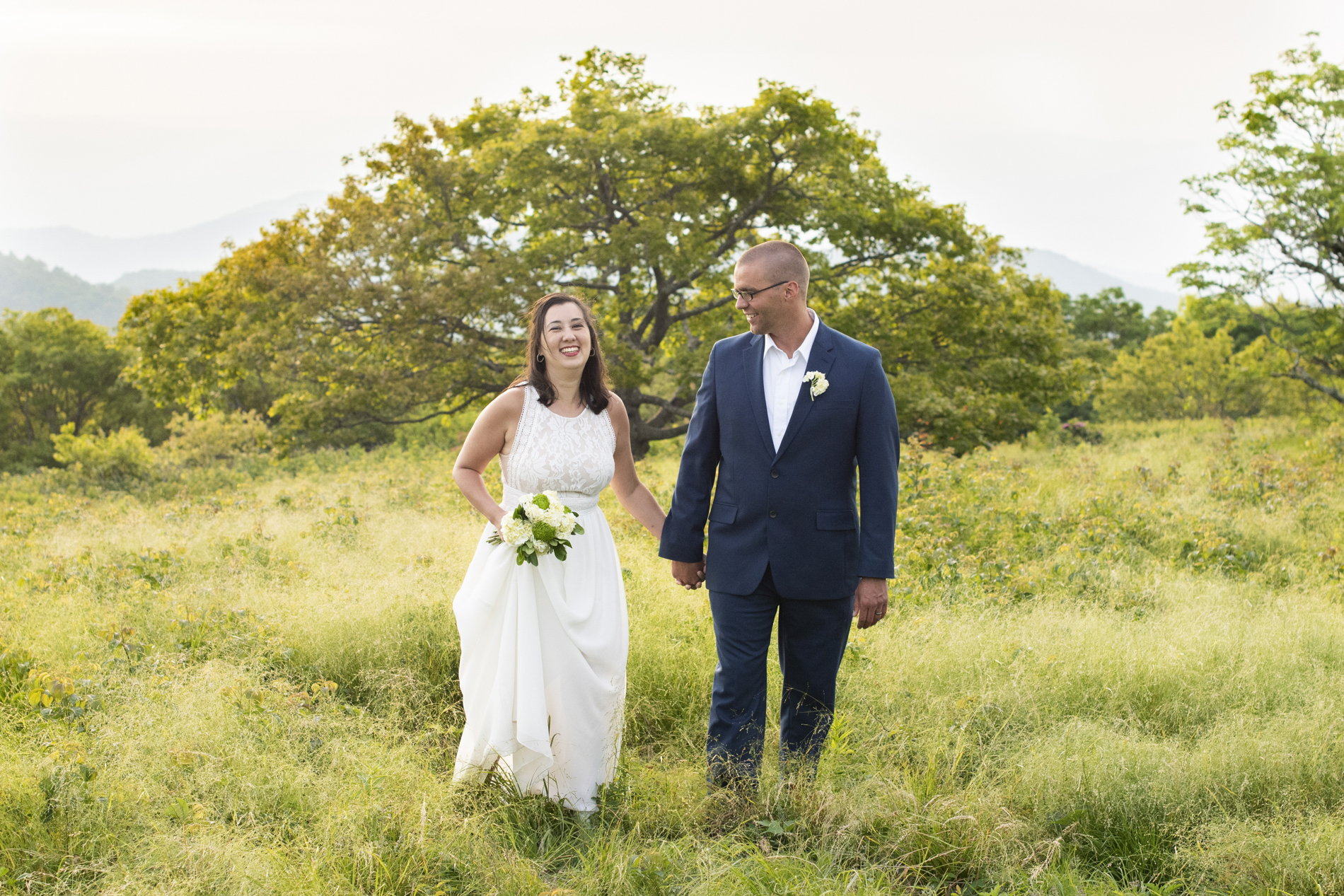 Couple standing in tall grass Craggy Gardens Wedding