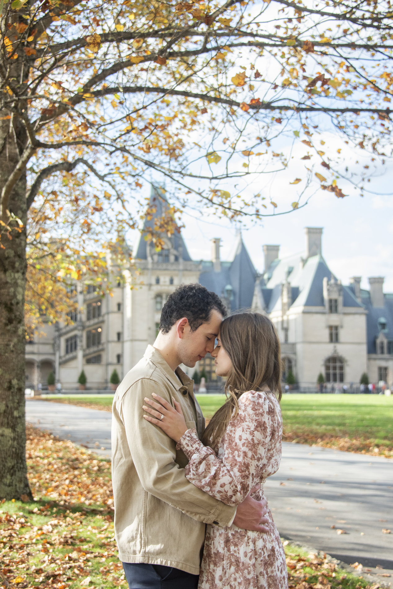 Biltmore Estate Engagement Photography during fall of couple snuggling