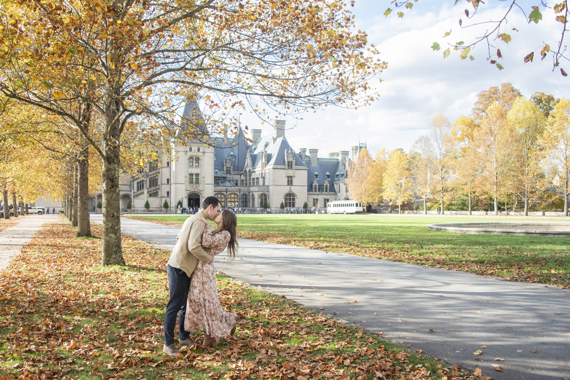 Biltmore Estate Engagement Photography during fall of couple kissing under tree