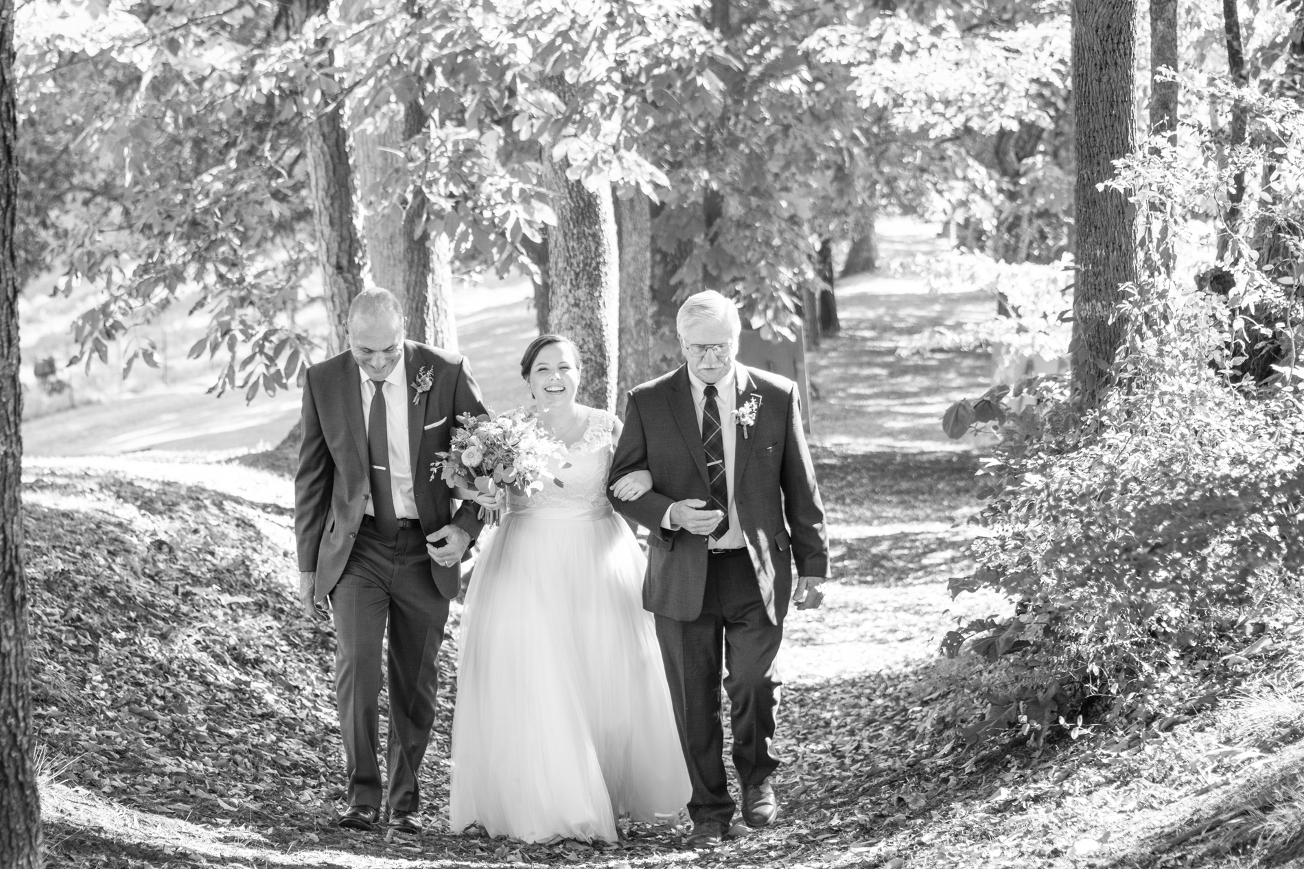 Bride walking with two Dads at Yesterday Spaces Asheville