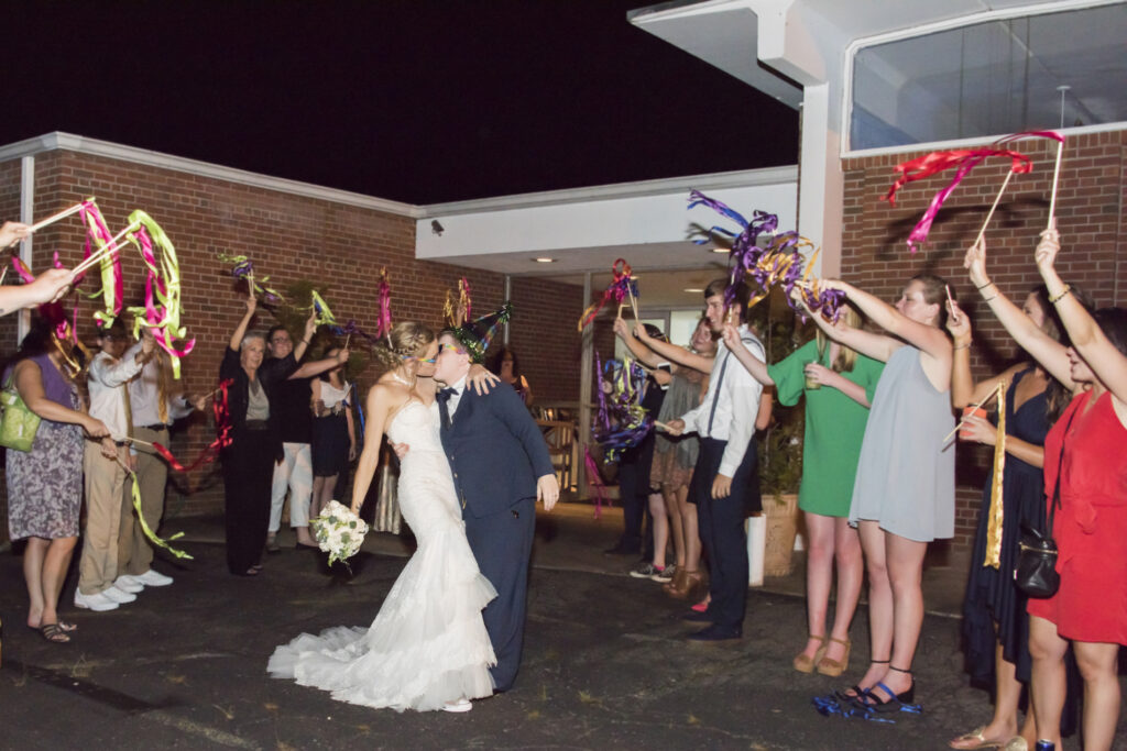 Couple kissing during wedding send off