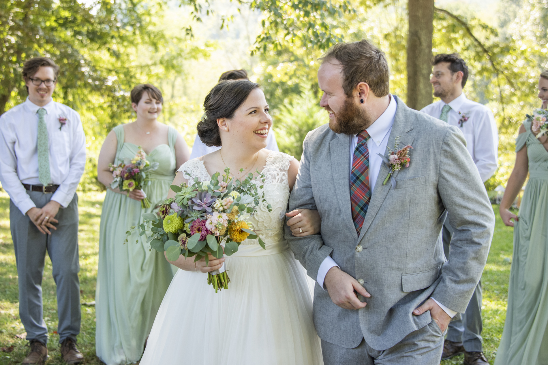 Wedding party photo with couple highlighted