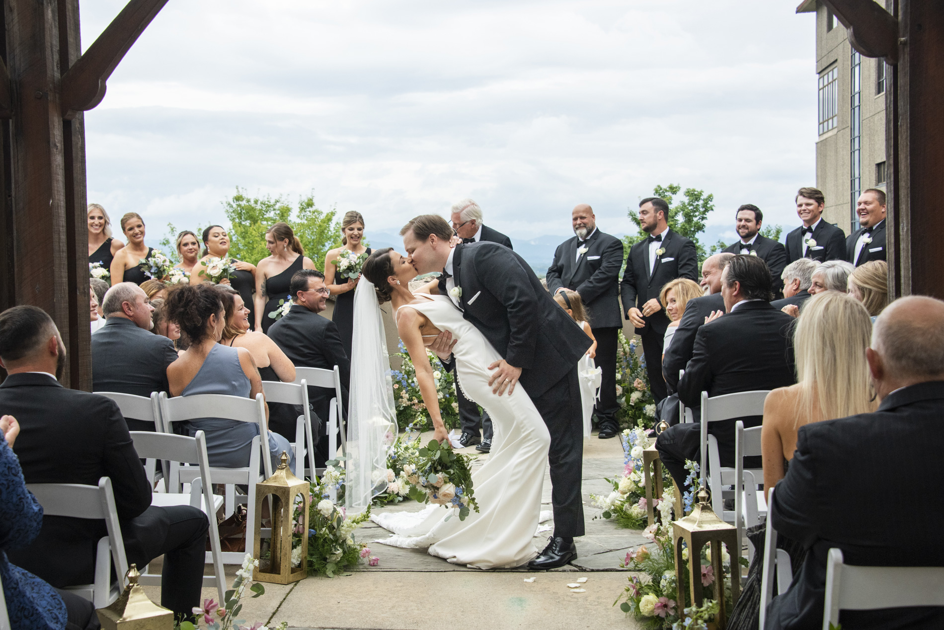 Couple kissing in aisle at wedding ceremony