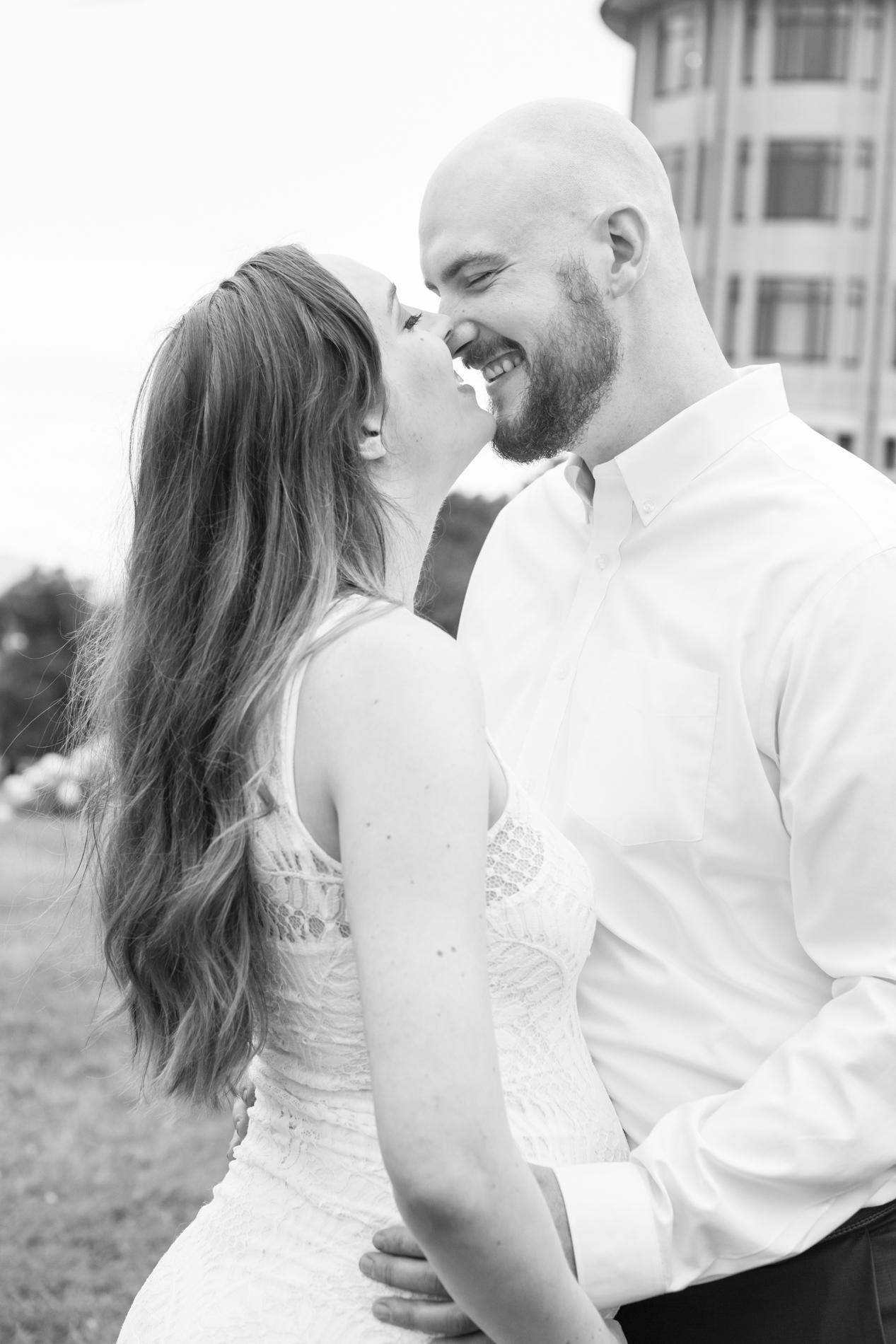 Couple touching noses during maternity photos