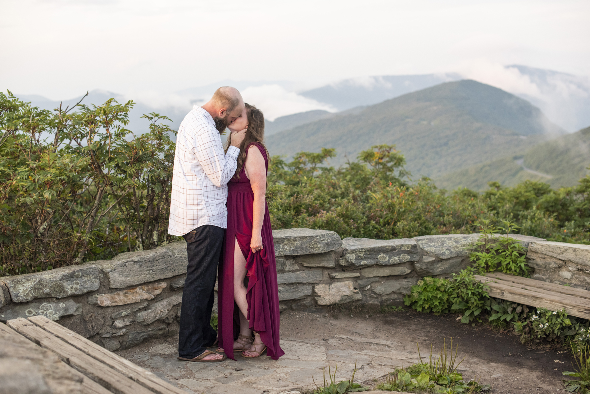 Craggy Gardens Engagement Photos of couple kissing with mountain views