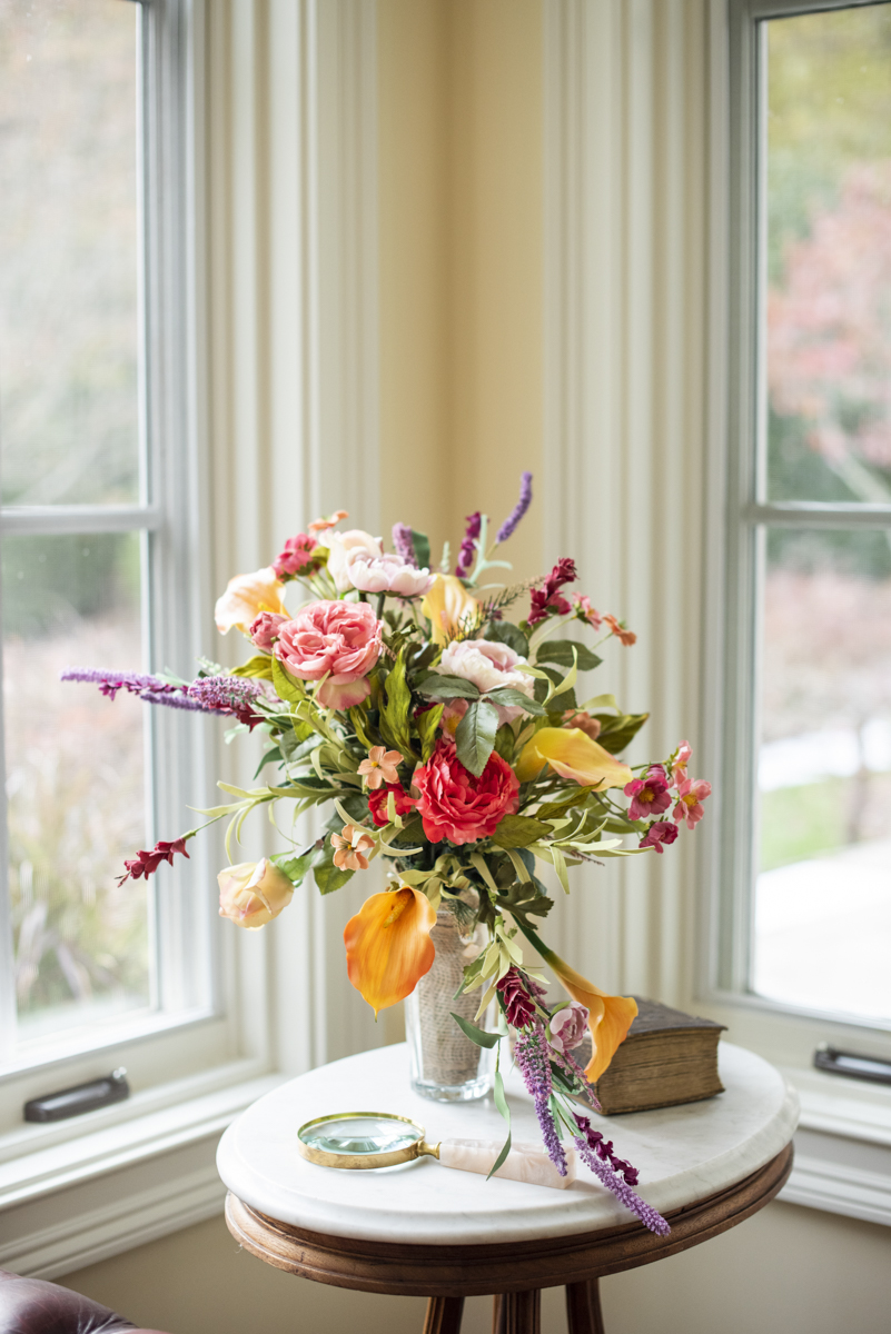 Fall bridal bouquet in front of windows