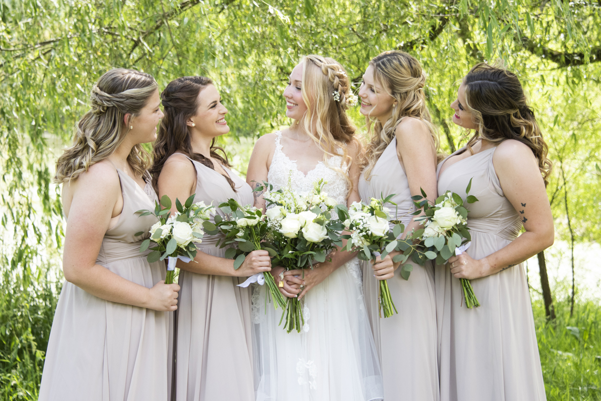 Bride and bridesmaids laughing