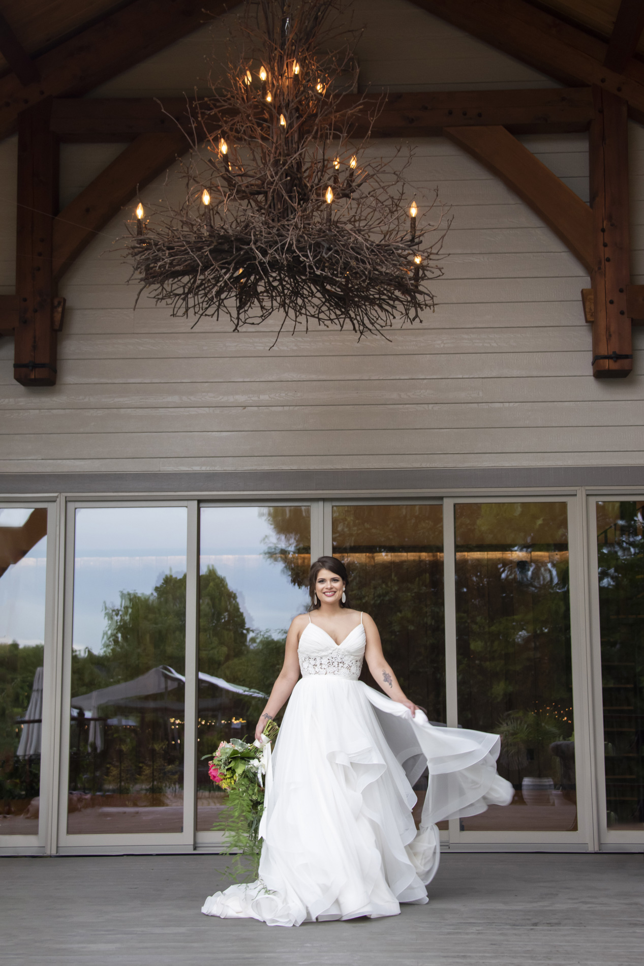 Bride letting the wind catch her dress at Haiku wedding