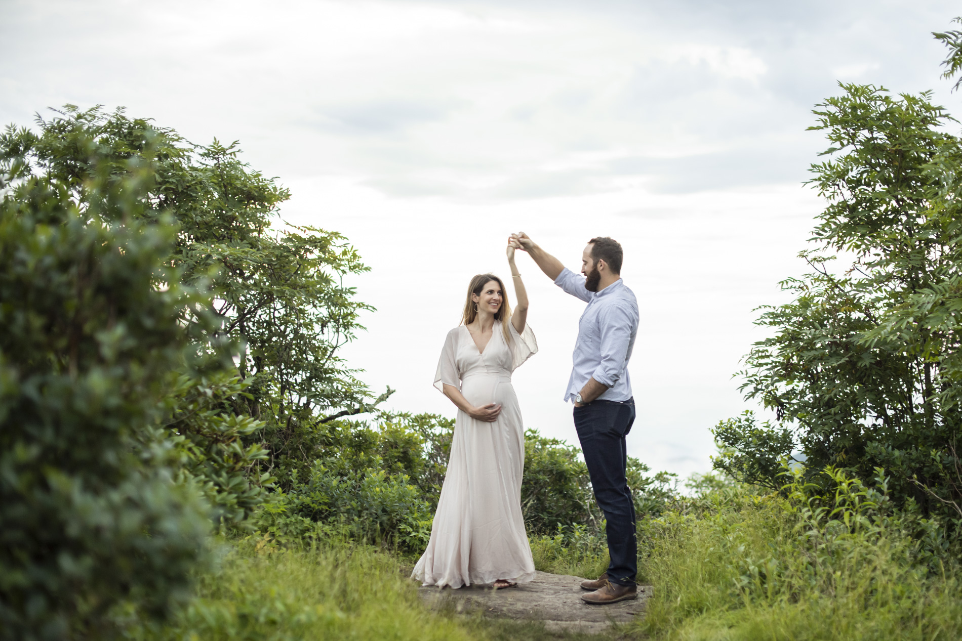 Couple dancing on mountain top during Maternity Photography in Asheville