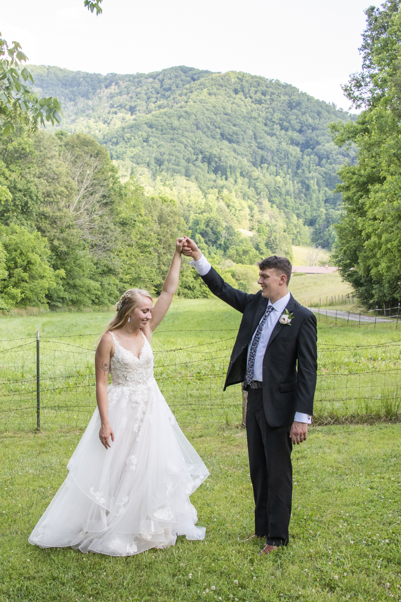 Couple dancing in grass at Claxton Farm wedding