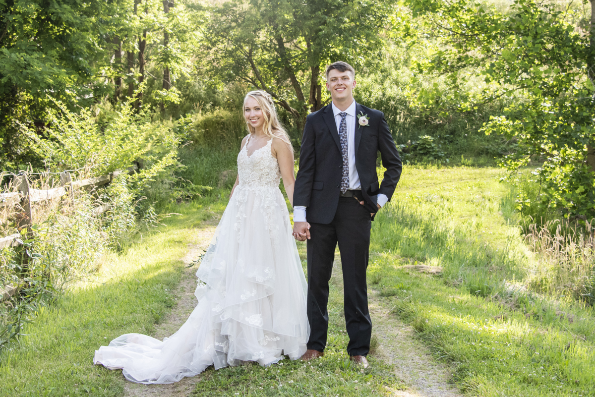 Couple holding hands at Claxton Farm Wedding