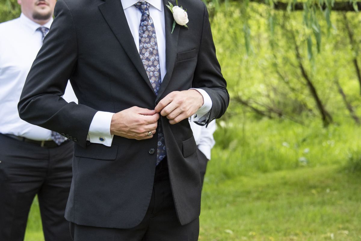 Groom buttoning jacket