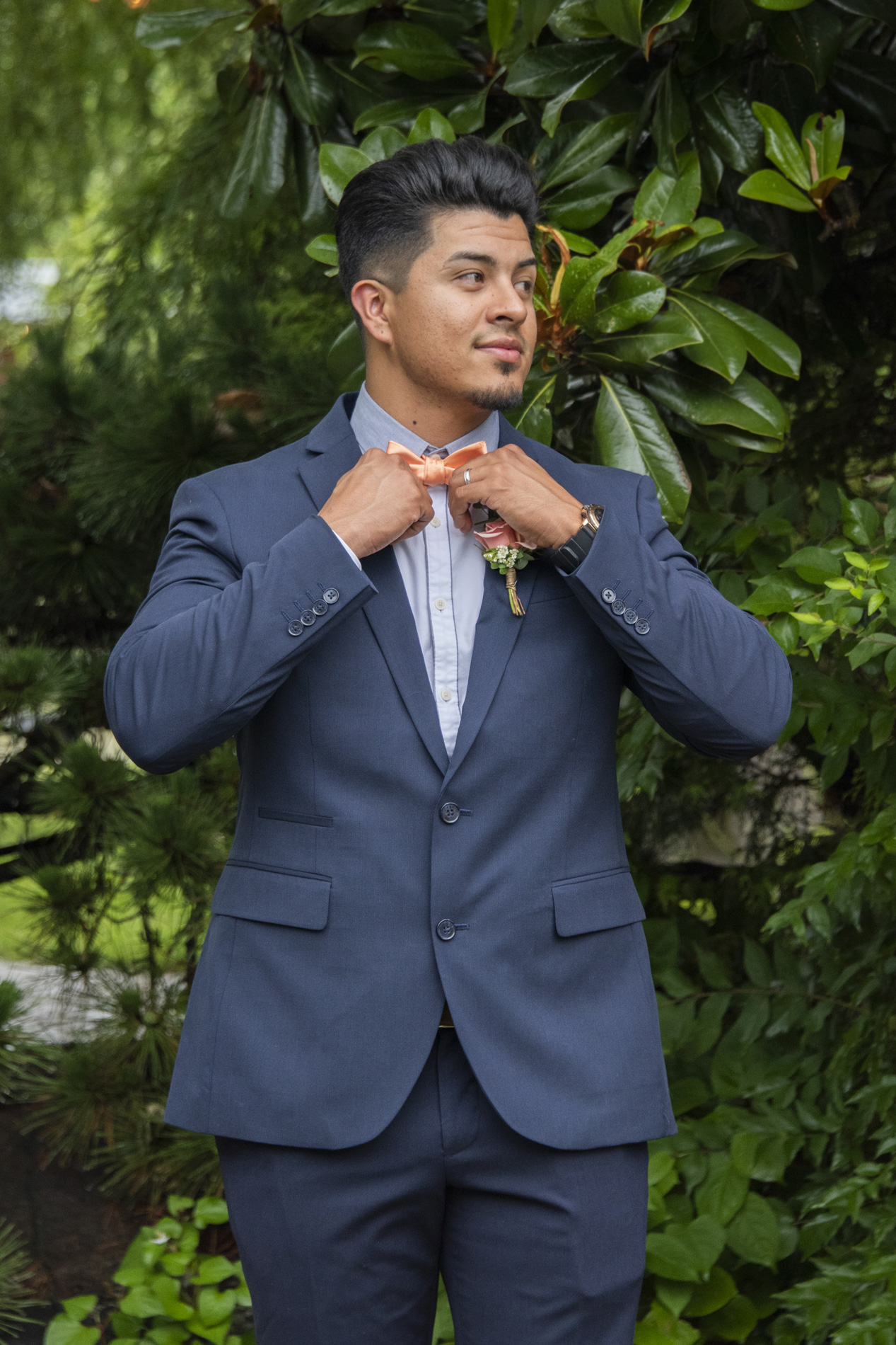 Groom fixing tie at Haiku wedding venue