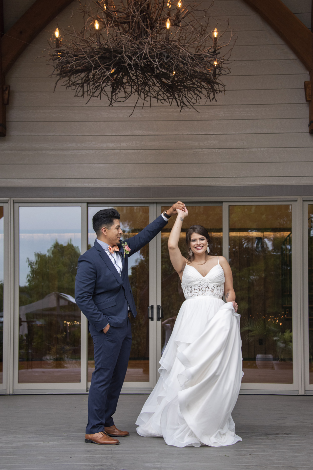 Groom spinning bride while dancing