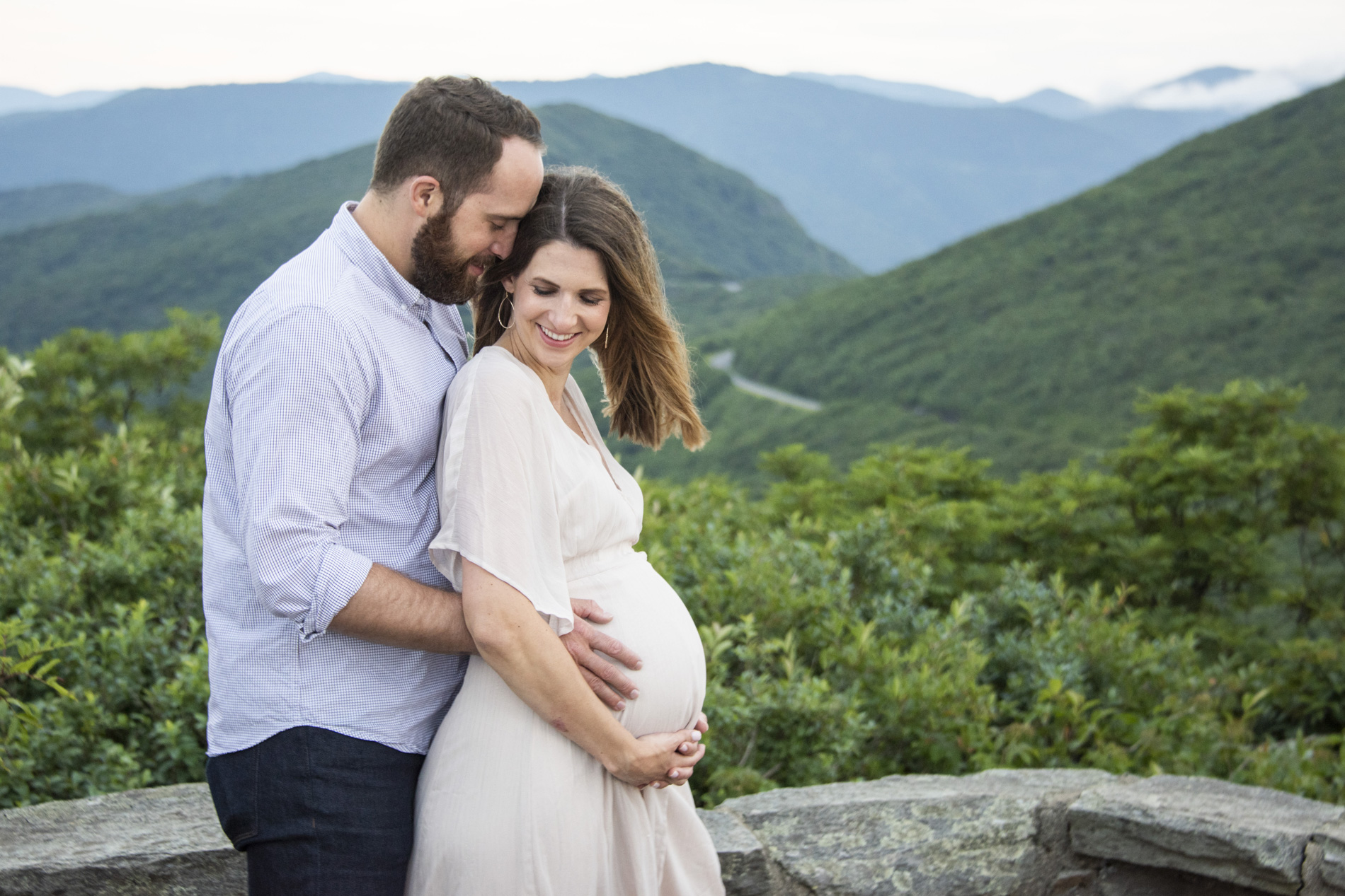 Maternity Photography in Asheville with couple snuggling