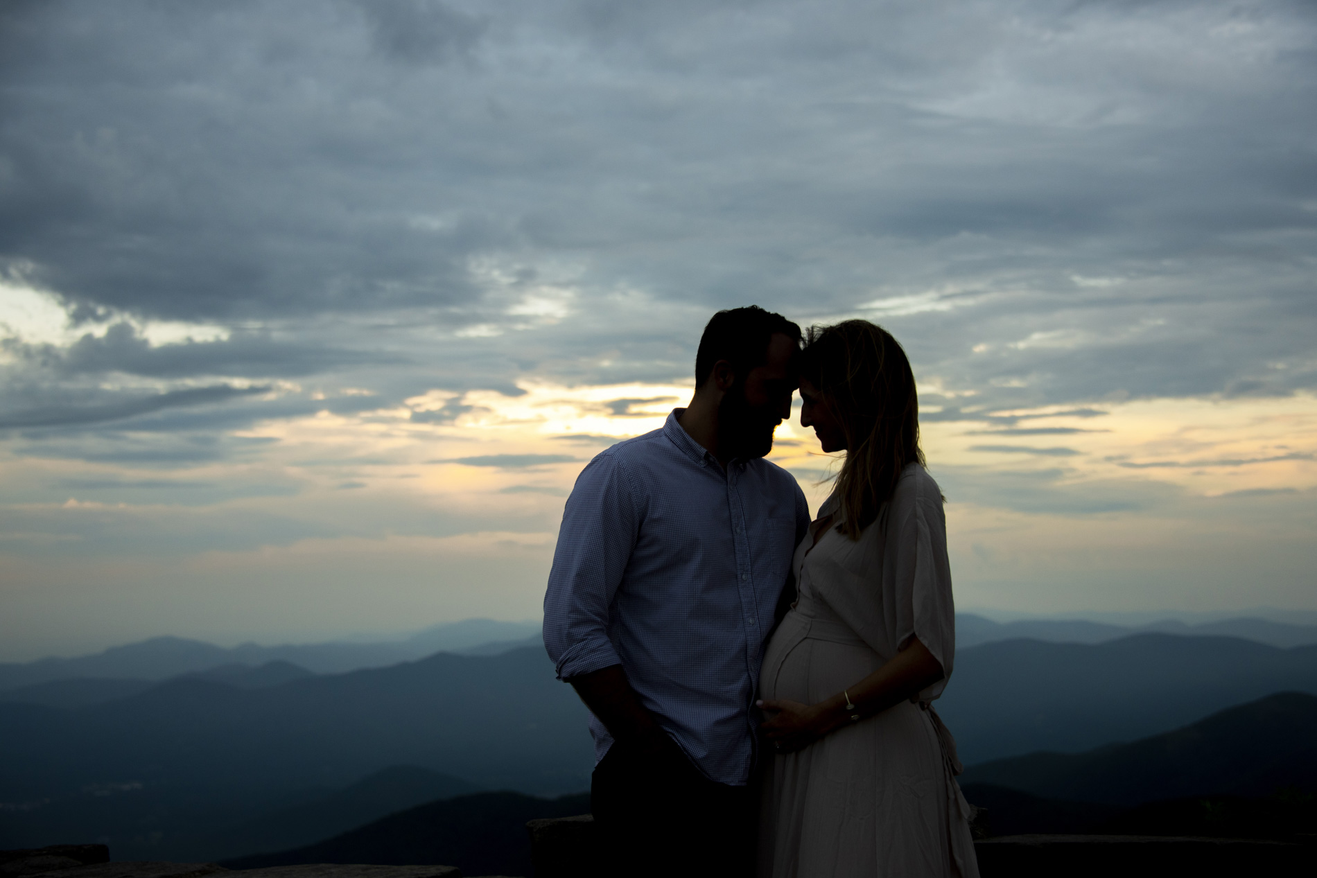 Couple touching foreheads at sunset in Asheville, NC