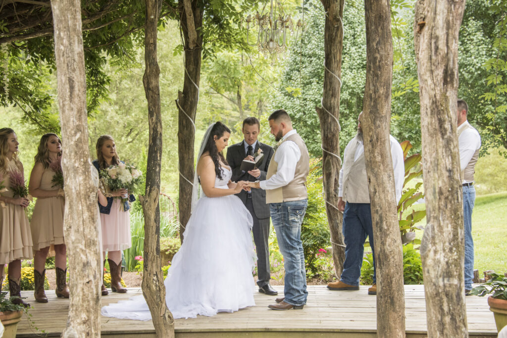 Couple exchanging rings during wedding at Timber Hall Events Wedding Photography