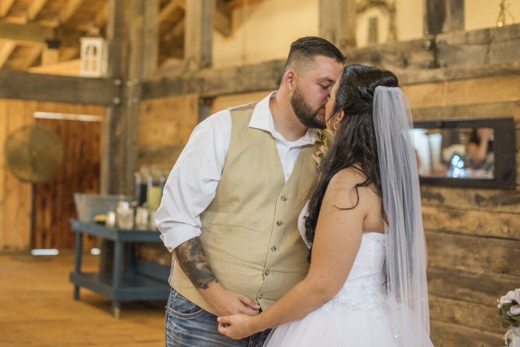 Couple kissing at Timber Hall Events Wedding Photography