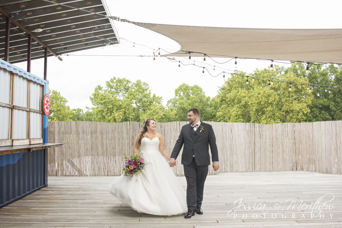 Highland Brewing Asheville Wedding with couple walking on rooftop