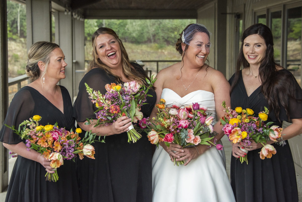 Bride and bridesmaids laughing at Connestee Falls Wedding