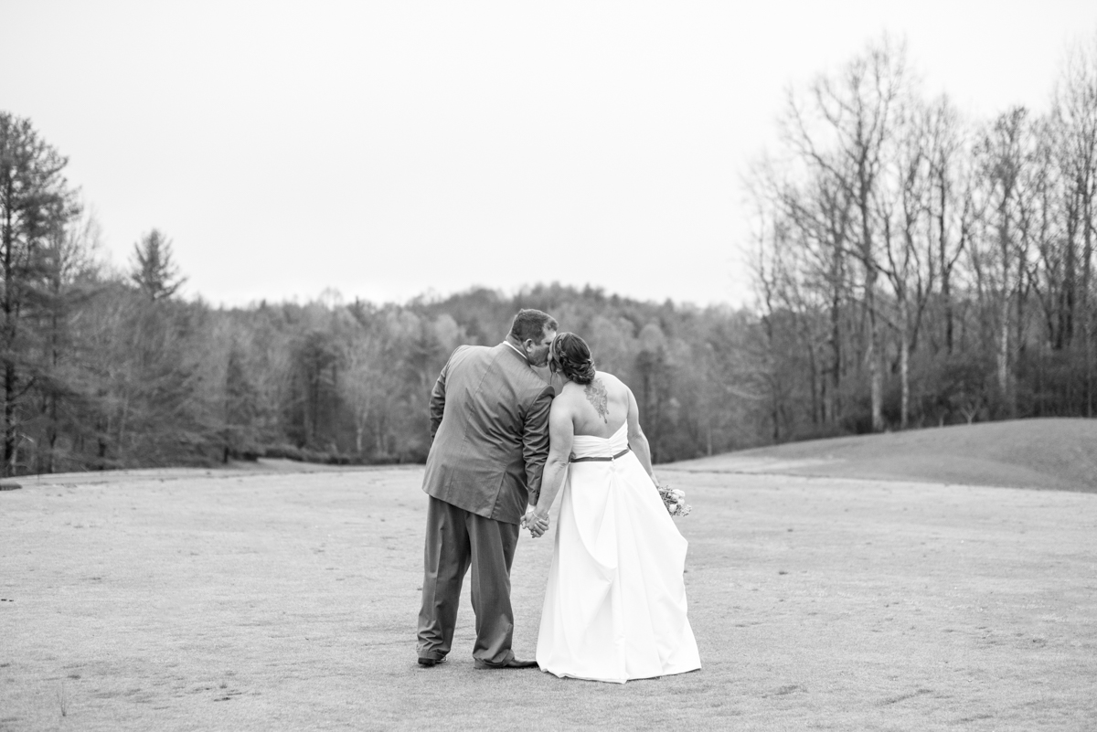 Couple's kissing at Connestee Falls Wedding