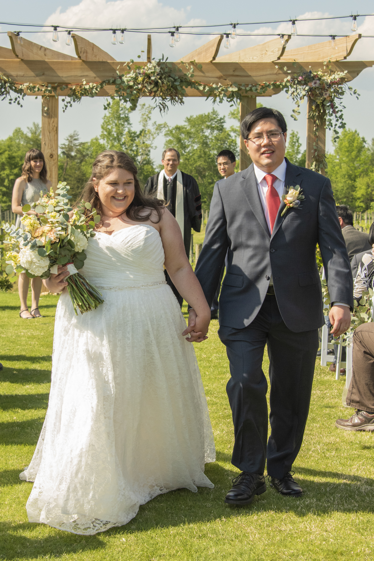 Couple walking down wedding aisle at Spinning Leaf Wedding