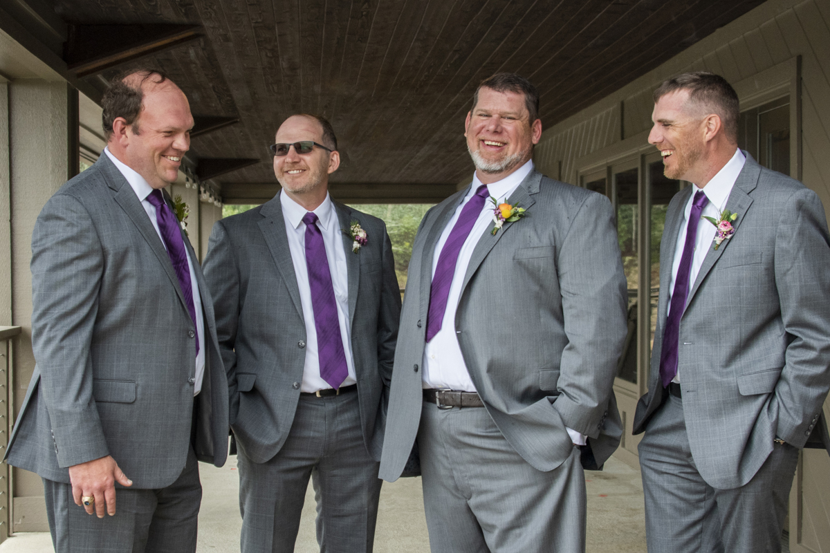 Groom and groomsmen laughing