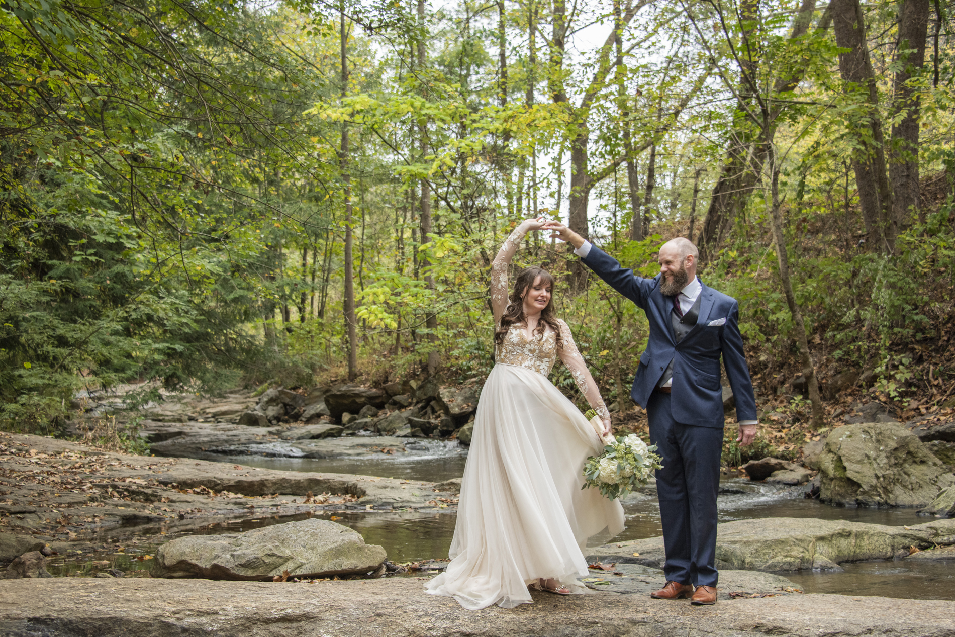 Groom spinning bride at Asheville botanical gardens wedding