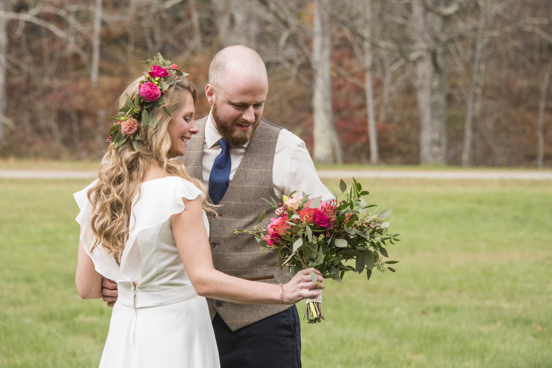 Bride and groom looking at bouquet